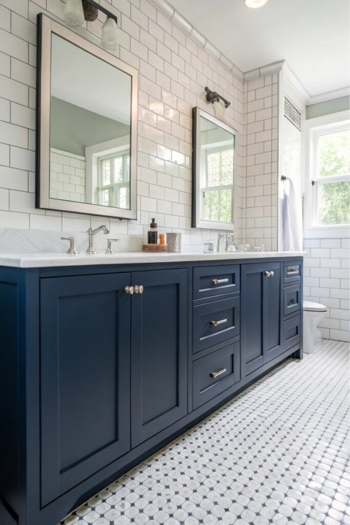 A bathroom with navy blue cabinets and white tile accents